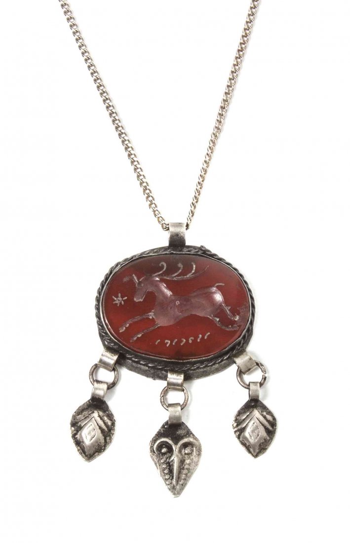 An Intaglio Cut Pendant, Width 1 1/2 inches.: An Intaglio Cut Pendant, of oval form, decorated with a ram, hung with four silver pendants. Width 1 1/2 inches. Property from the Estate of Dr. Ivan Jeanne Weiler, Urbana, Illinois