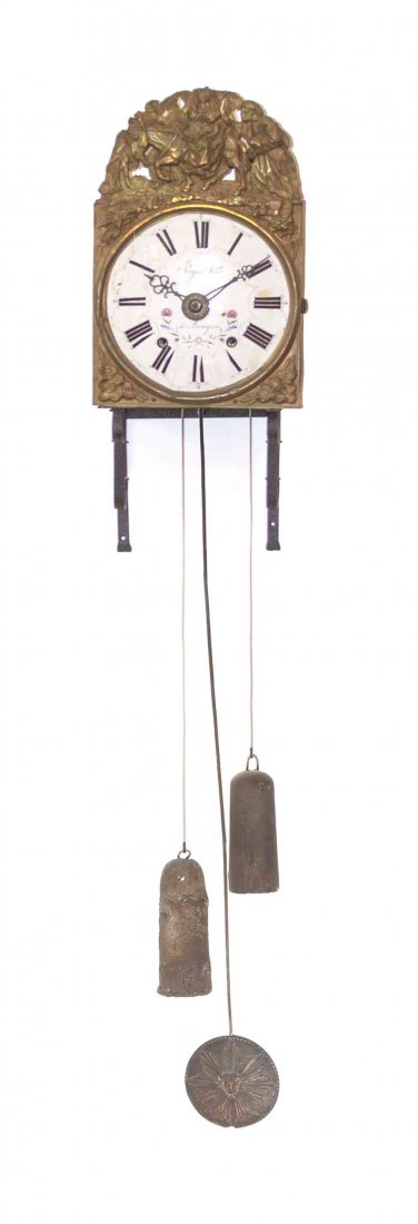 A French Brass Wag on the Wall Clock, Regis Novat,: A French Brass Wag on the Wall Clock, Regis Novat, having an enameled circular dial with Roman hours within a pressed brass frame depicting a figural scene. Height 16 1/2 x width 10 1/2 inches. Proper