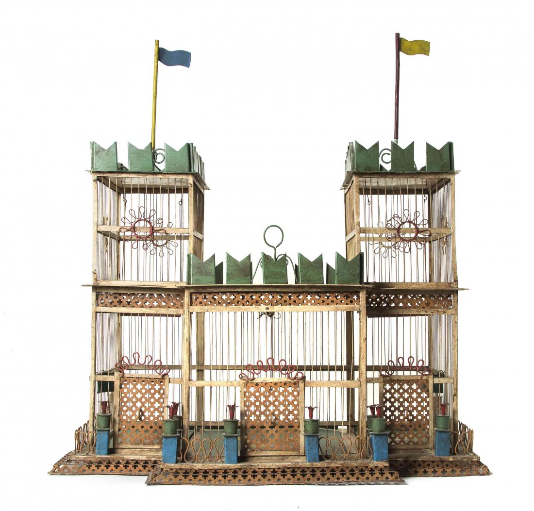 A Tole Architectural Birdcage, Height overall 30 3/4 x: A Tole Architectural Birdcage, in the form of a turreted residence, having flags and battlements to the roof, the base set with a fence and potted plants. Height overall 30 3/4 x width 28 x depth 18 1