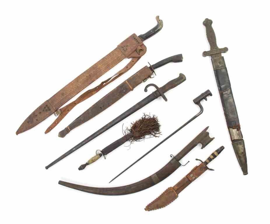 A Collection of Bladed Weapons, Length of longest: A Collection of Bladed Weapons, comprising a Middle Eastern curved short sword, a North African short sword, a 19th century European short sword, a South American machete with a bone handle, a 19th ce