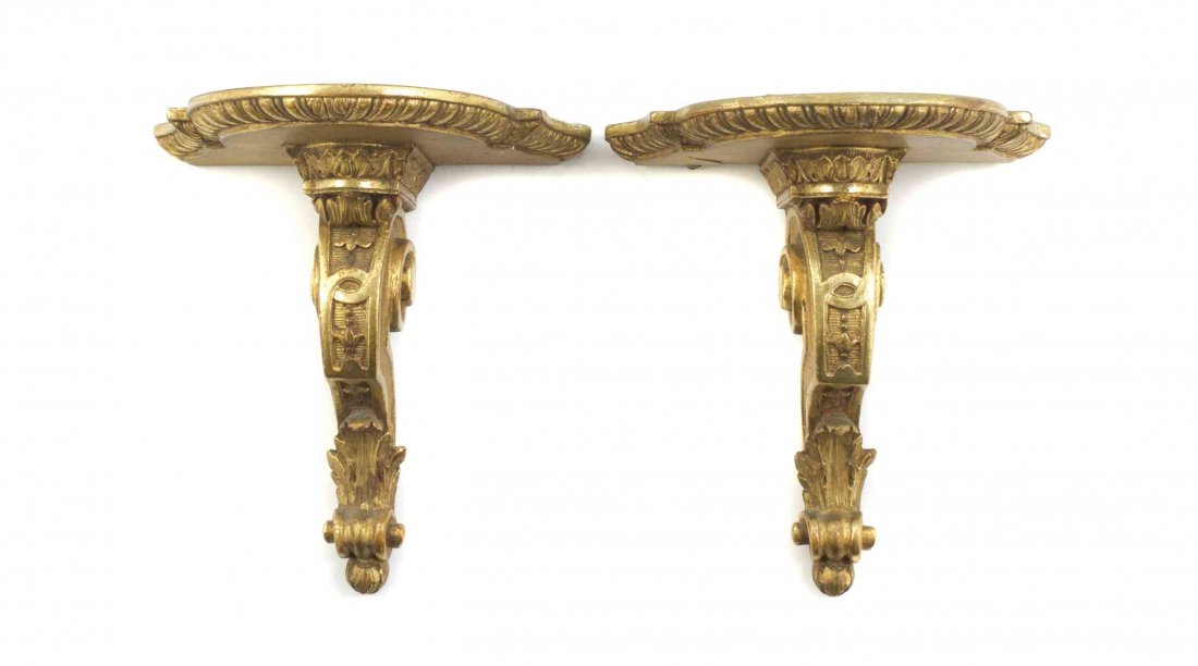 A Pair of Giltwood Wall Brackets, Height 8 1/2 inches.: A Pair of Giltwood Wall Brackets, each having a serpentine top with an egg and dart decorated edge, raised on a scrolling support. Height 8 1/2 inches.