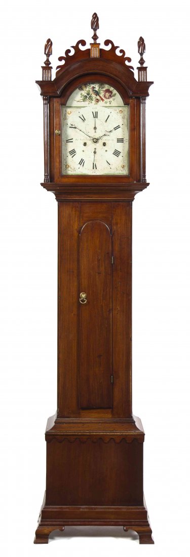 An American Various Woods Tall Case Clock, Jas: An American Various Woods Tall Case Clock, Jas Anderson, West Haven, Connecticut, having a scrolling cornice with flame finials over the arched glazed door revealing the conforming painted dial decora