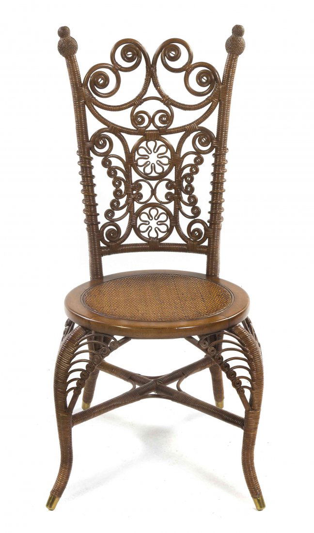 A Victorian Wicker Desk Chair, Height 37 1/2 inches.: A Victorian Wicker Desk Chair, having a pierced back with scroll decoration over the circular caned seat, raised on cabriole legs joined by an X-form stretcher, ending in brass caps. Height 37 1/2 inc