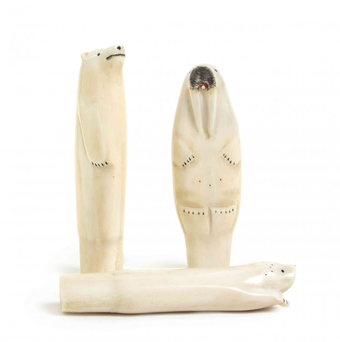 Three Carved Marine Ivory Walking Stick Handles, Height: Three Carved Marine Ivory Walking Stick Handles, one in the form of a bear, one a seal and one a walrus. Height of tallest 5 1/4 inches. Property from the Private Collection of Leon Shapiro, Evanston,