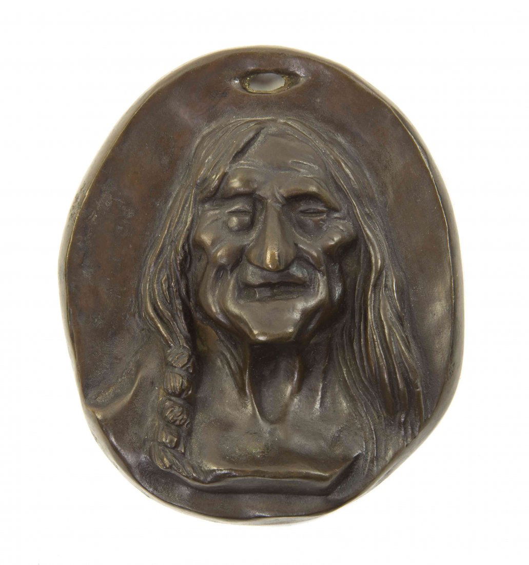 An American Bronze Medallion, Charles Russell, Height 4: An American Bronze Medallion, Charles Russell, of oval form, depicting a Native American, the verso incised C.M. Russell. Height 4 1/4 inches.