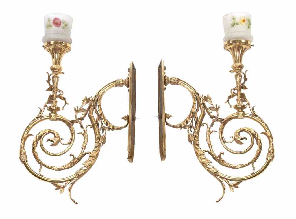 A Pair of Neoclassical Brass Sconces, Height overall 28: A Pair of Neoclassical Brass Sconces, each of scrolling form with foliate decoration, stamped Y&T, with associated molded and reverse painted shades with floral decoration. Height overall 28 1/8 inche