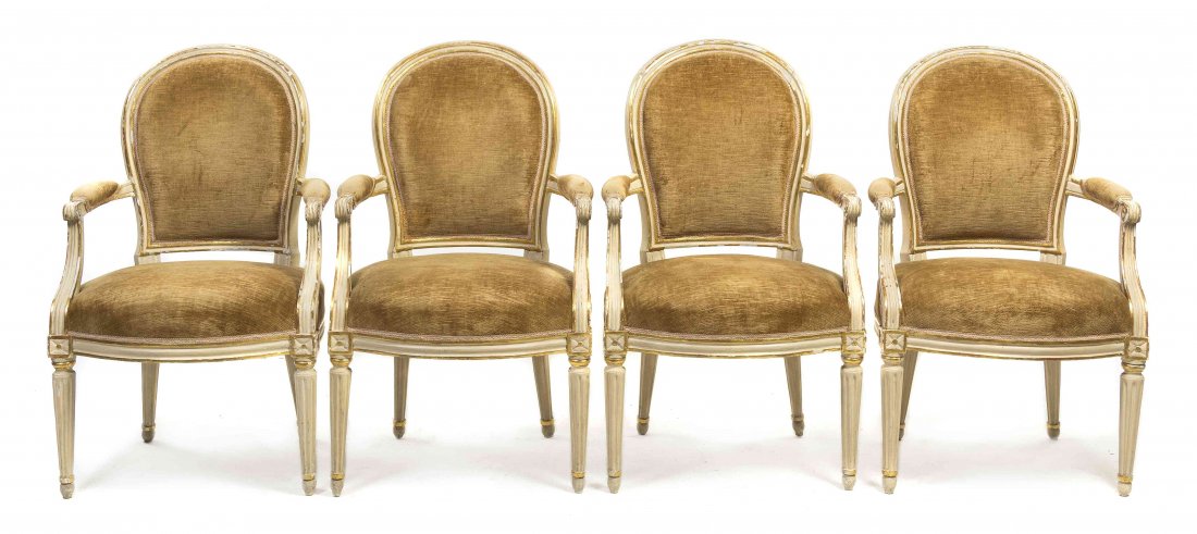 A Set of Four Louis XVI Style Painted and Parcel Gilt: A Set of Four Louis XVI Style Painted and Parcel Gilt Fauteuils en Cabriolet, en suite with lot 815, each having an arched upholstered back, arms and seat, raised on fluted tapering legs. Height 37 1/