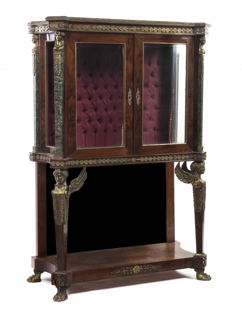 An Empire Style Gilt Metal Mounted Walnut Vitrine: An Empire Style Gilt Metal Mounted Walnut Vitrine Cabinet, having a stepped cornice over a frieze with foliate decoration, above two glazed panel doors opening to a velvet lined tufted interior, flank