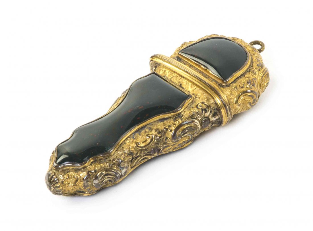 A French Gilt Metal Etui Case, Length 4 inches.: A French Gilt Metal Etui Case, of cartouche form cast with foliate decoration, the button release lid opening to a fitted interior with a pocket knife, a spoon, a pick and a square. Length 4 inches. P