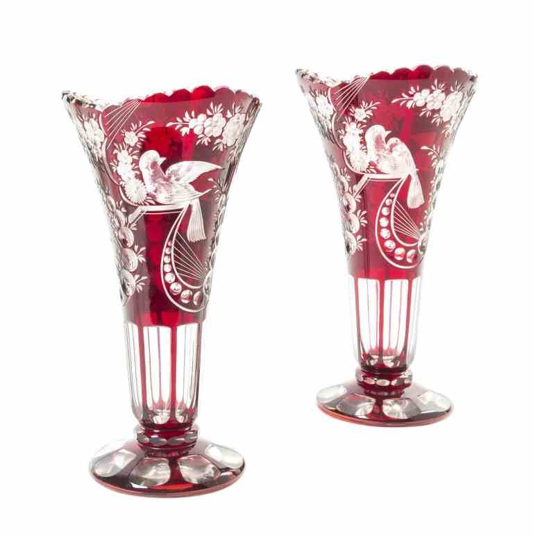 A Pair of Bohemian Cranberry Cut to Clear Glass Trumpet: A Pair of Bohemian Cranberry Cut to Clear Glass Trumpet Vases, each having a scalloped mouth above the bird and foliate decorated body, raised on a circular foot. Height 12 inches.