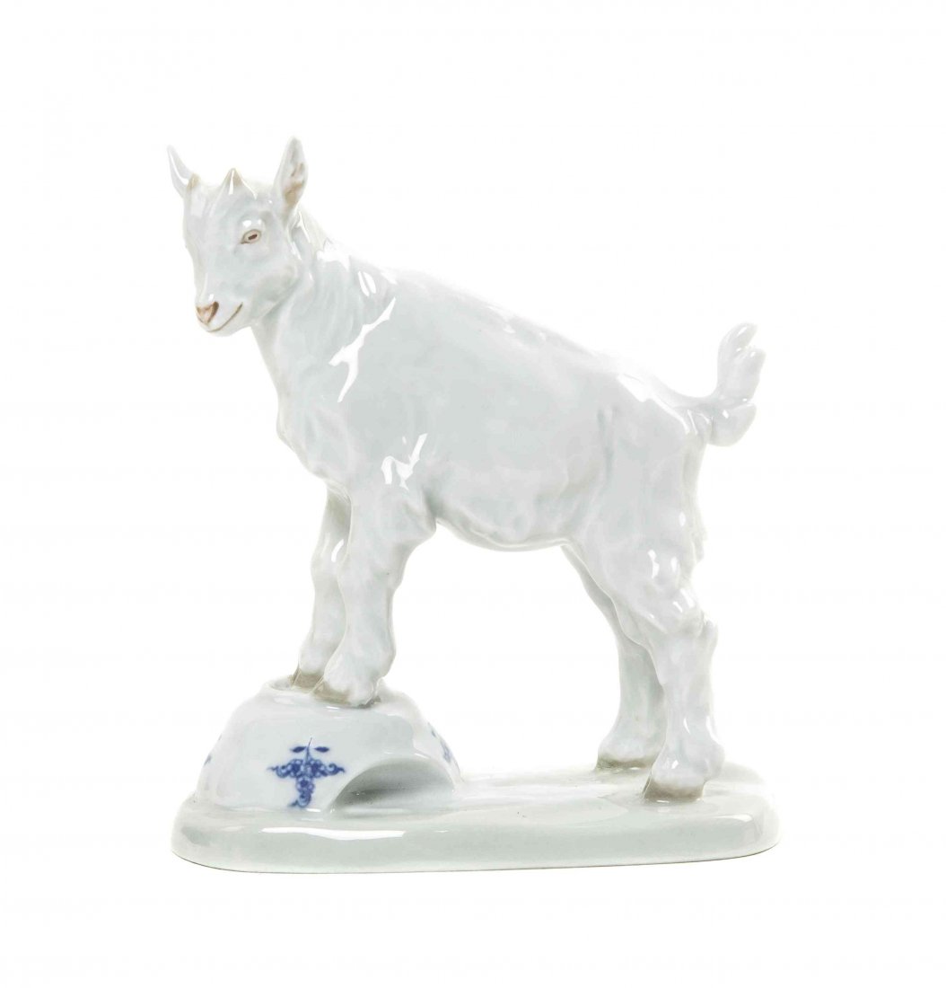 A Meissen Porcelain Animalier Figure, Height 5 5/8: A Meissen Porcelain Animalier Figure, modeled by Erich Hosel, depicting a kid goat standing above a broken Blue Onion plate with spilled milk, impressed 50, incised V107, with crossed swords mark in u