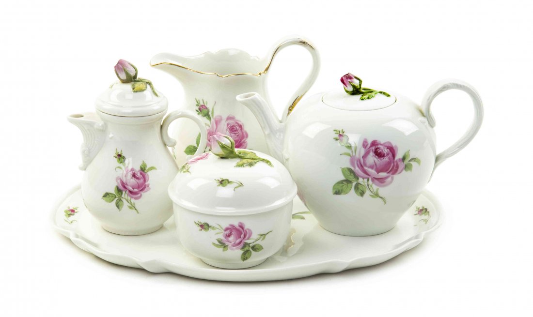 A Meissen Porcelain Tea Service, Width of tray 11: A Meissen Porcelain Tea Service, comprising a teapot, a creamer, a covered sugar, a covered milk pitcher and a tray, each painted with roses on a white ground, having crossed swords mark in underglaze