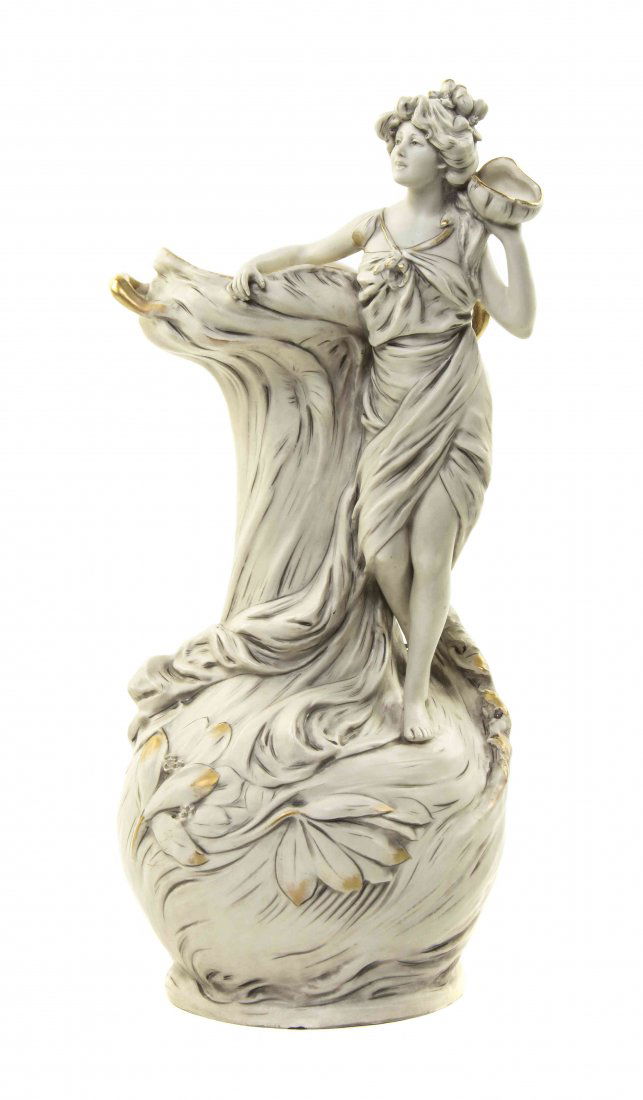 A Royal Dux Porcelain Figural Vase, Height 17 inches.: A Royal Dux Porcelain Figural Vase, of bottle form, decorated with an applied Art Nouveau maiden holding a shell to her ear, the body of the vase further decorated with flowers, base impressed 653. He