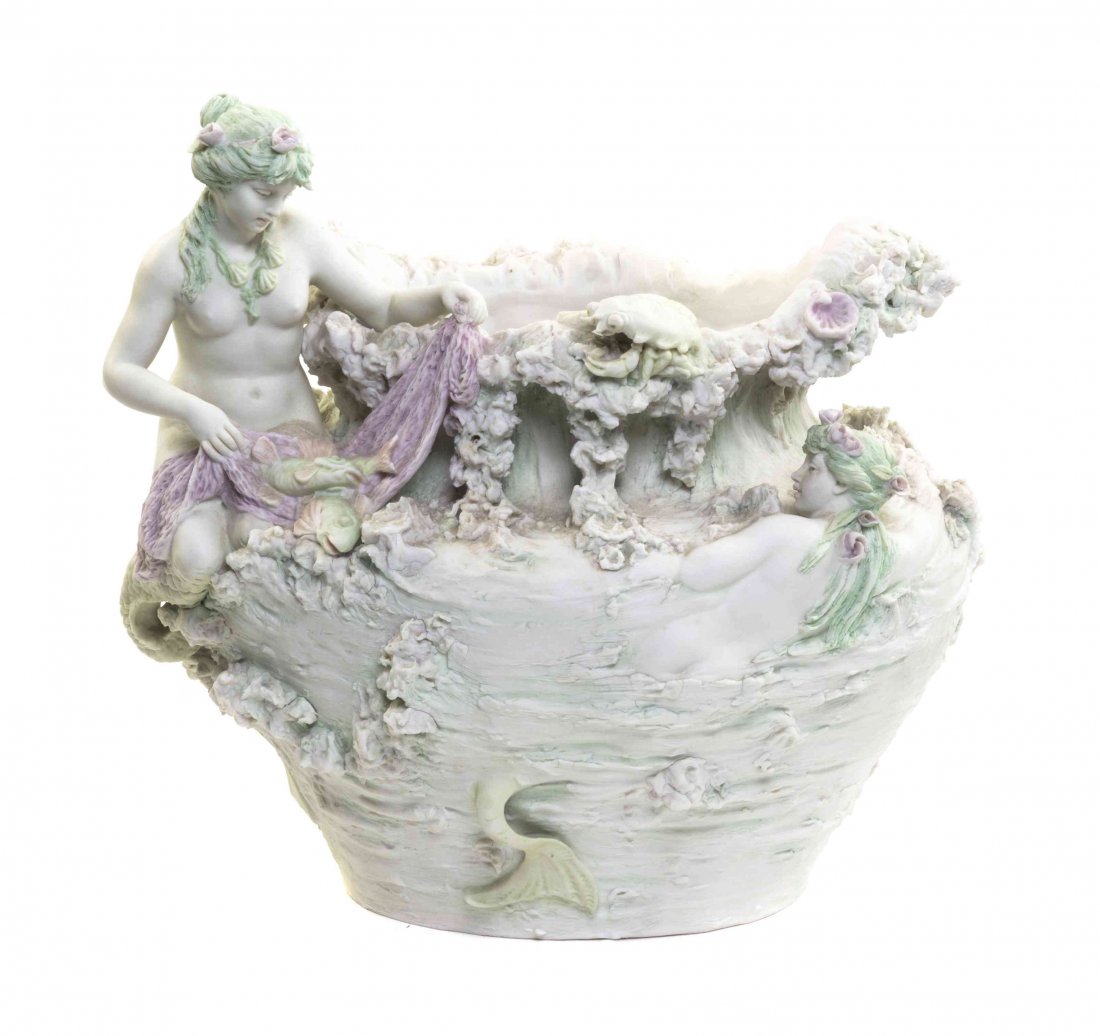 A Royal Dux Porcelain Figural Jardiniere, Height 11 1/2: A Royal Dux Porcelain Figural Jardiniere, of flattened ovoid form, applied with two mermaids, a crab, a lobster and other sea life, the base impressed 180/16. Height 11 1/2 x width 12 1/4 inches.