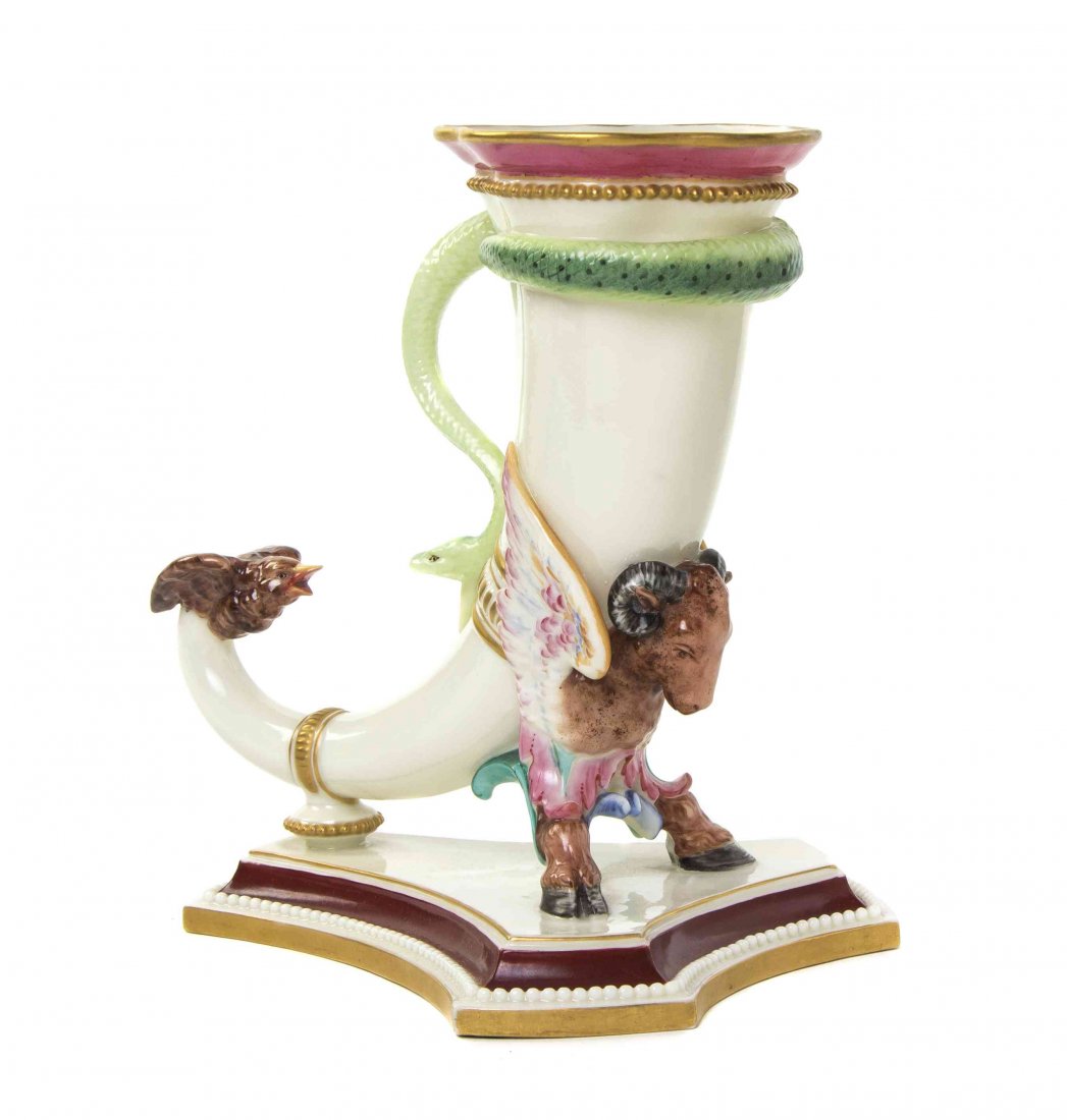 A Royal Worcester Porcelain Cornucopia, Height 7 1/2: A Royal Worcester Porcelain Cornucopia, 1868, having a serpent form handle and bird form tip, raised on a winged ram form foot, set on a tripartite base. Height 7 1/2 inches.