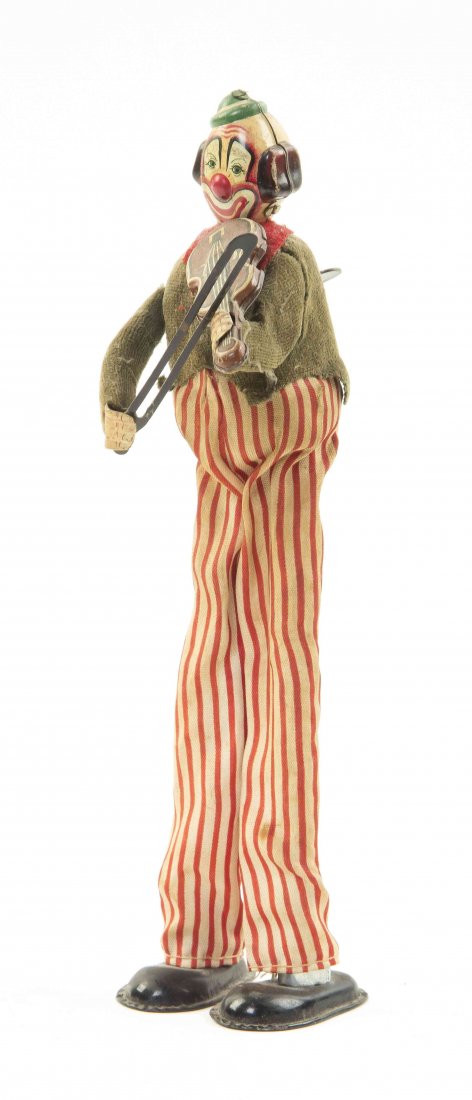 A Japanese Tin Wind-Up Toy, TPS, Height 8 3/4 inches.: A Japanese Tin Wind-Up Toy, TPS, Happy Violinist, depicting a clown playing the violin, when wound the figure sways and moves his right arm simulating the playing of a violin. Height 8 3/4 inches.