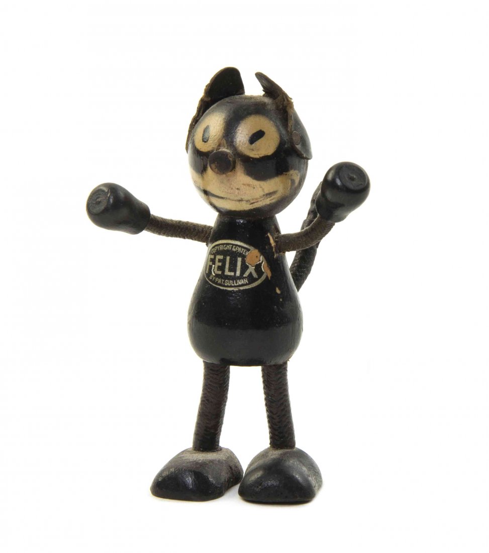 An American Painted Wood Figure, Height 3 1/4 inches.: An American Painted Wood Figure, circa 1920's, depicting Felix the Cat, having leather ears and wire arms and tail, with allover paint decoration, with Copyright & Patent by Pat. Sullivan label to fro