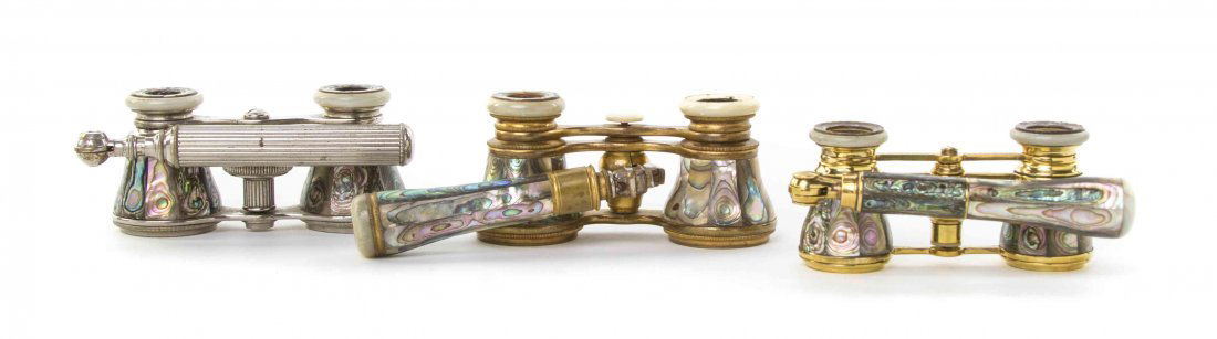 Three Pairs of French Abalone Veneered Opera Glasses,: Three Pairs of French Abalone Veneered Opera Glasses, one by Duvelleroy, Paris, each having faceted veneers with a swing handle, and abalone veneered eyepieces, two with brass frames and one with a st