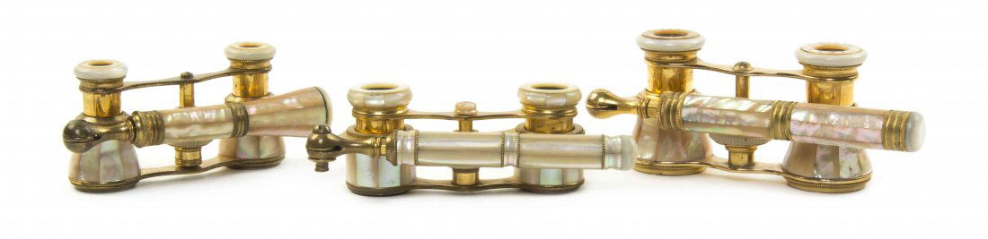 Three Pairs of French Mother-of-Pearl Veneered Opera: Three Pairs of French Mother-of-Pearl Veneered Opera Glasses, comprising one example by Iris and one by Colmont, one having barrel form cylinders, each with faceted veneers and a swing handle, with mo