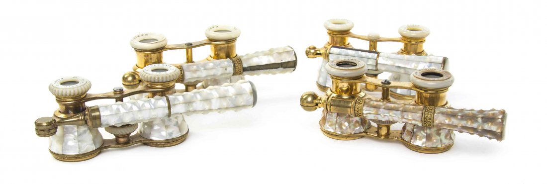 Four Pairs of French Mother-of-Pearl Veneered Opera: Four Pairs of French Mother-of-Pearl Veneered Opera Glasses, comprising examples by Audemair, La Reine, La Princesse and Merveille et Cie, each having textured faceted cylinders and swing handle with