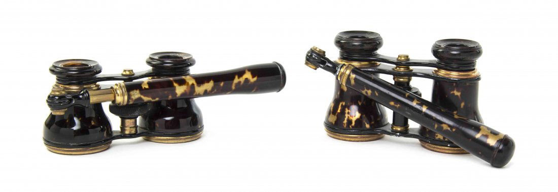 Two Pairs of Tortoise Shell or Faux Tortoise Shell: Two Pairs of Tortoise Shell or Faux Tortoise Shell Veneered Opera Glasses, one by Dixon & Hempenstall, Dublin, the other P. Durfeel, Berlin, each having a swing handle and set in an ebonized frame. Wi