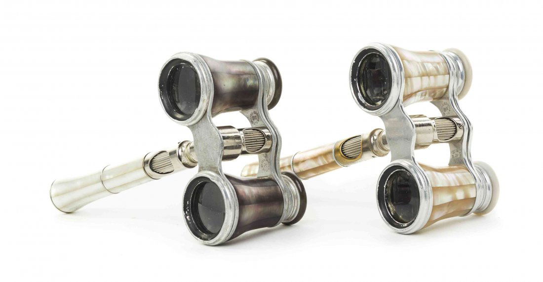 Two Pairs of French Mother-of-Pearl Veneered Opera: Two Pairs of French Mother-of-Pearl Veneered Opera Glasses, Lemaire, Paris, each having faceted veneers and a central handle with mother-of-pearl eyepieces and set in a steel frame. Width of wider 3 3