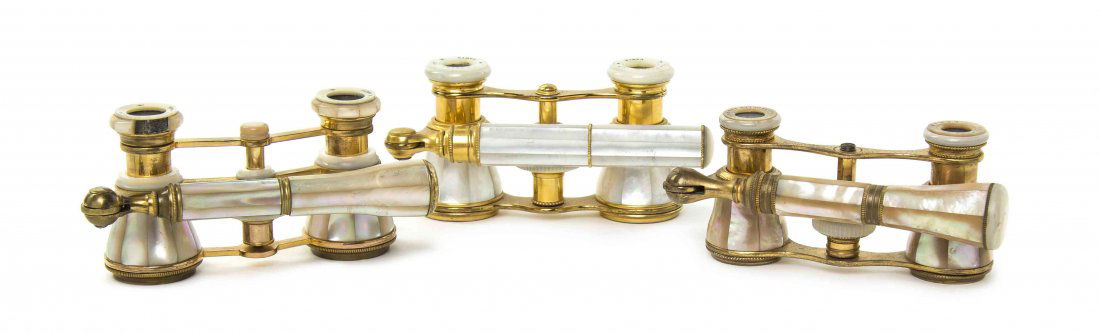 Three Pairs of Mother-of-Pearl Veneered Opera Glasses,: Three Pairs of Mother-of-Pearl Veneered Opera Glasses, comprising examples by Colmont and Lemaire, each having mother-of-pearl eyepieces, a swing handle and focal wheel, with a brass frame. Width of w