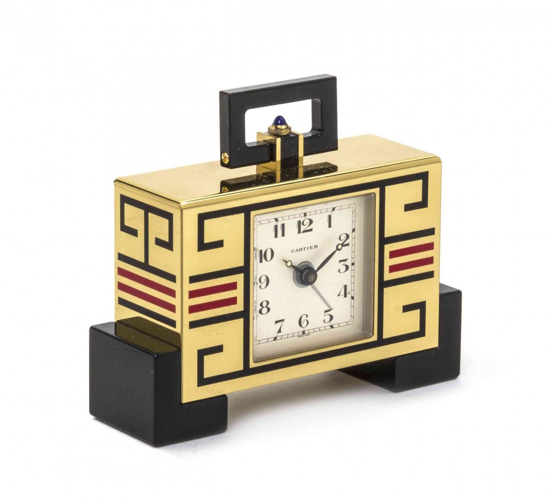 An Art Deco Style Gilt Brass and Enameled Desk Clock,: An Art Deco Style Gilt Brass and Enameled Desk Clock, Must de Cartier, No. 03456, Ref. 8914, of rectangular form, with geometric decoration in red and black, raised on block feet, complete with the or