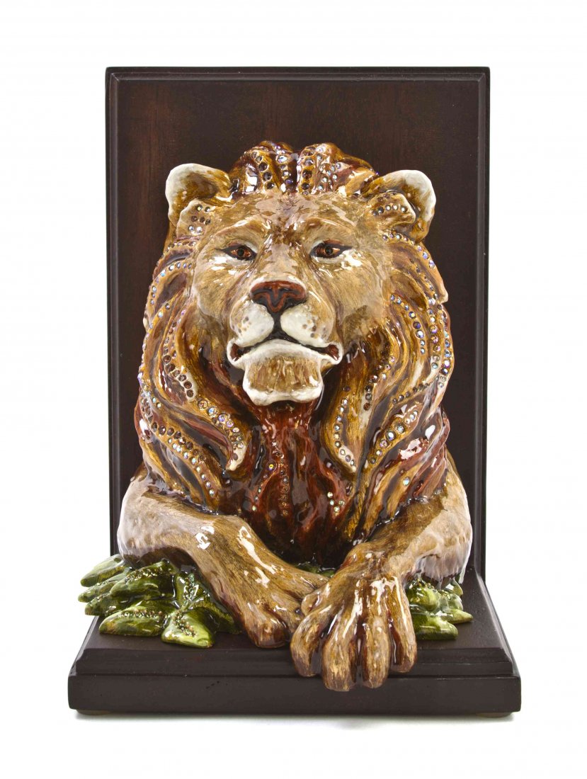A Jay Strongwater Animalier Mounted Bookend, Height 8: A Jay Strongwater Animalier Mounted Bookend, titled Arkin, from the Jungle Collection, depicting a lion with polychrome, enamel and crystal decoration, raised on a mahogany support, with original box 