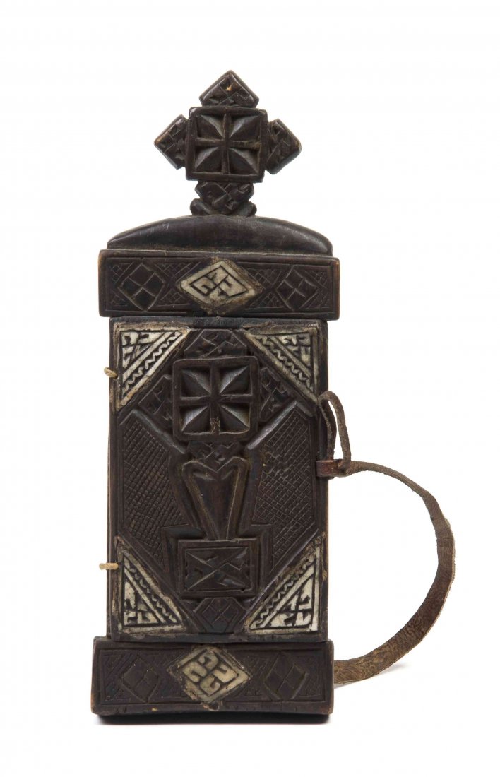 An African Carved Wood Shrine, Height overall 11 1/2: An African Carved Wood Shrine, of rectangular form with a cruciform finial, the leather hinge opening to a reveal a painted scene depicting Jesus and John the Baptist preaching, together with a relief