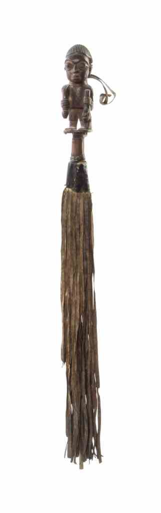 An African Carved Wood and Leather Whip, Length overall: An African Carved Wood and Leather Whip, having a figural handle. Length overall 31 inches. Property from the Estate of Jeanne Marienthal Westcott, Chicago, Illinois