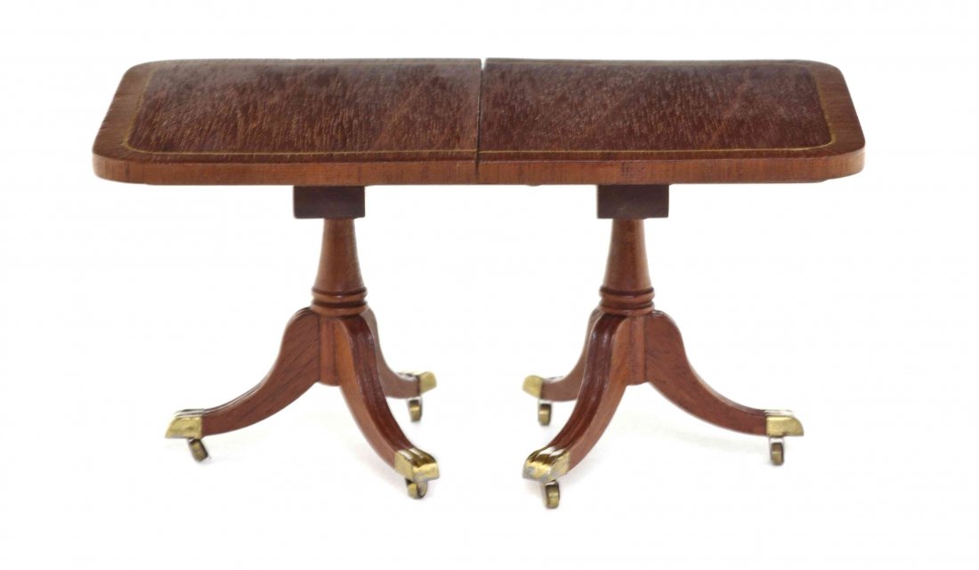 A Georgian Style Mahogany Double Pedestal Extension: A Georgian Style Mahogany Double Pedestal Extension Dining Table, Denis E. W. Hillman, having a rectangular top with line inlay and rounded corners set on turned tapering standards with tripartite spl