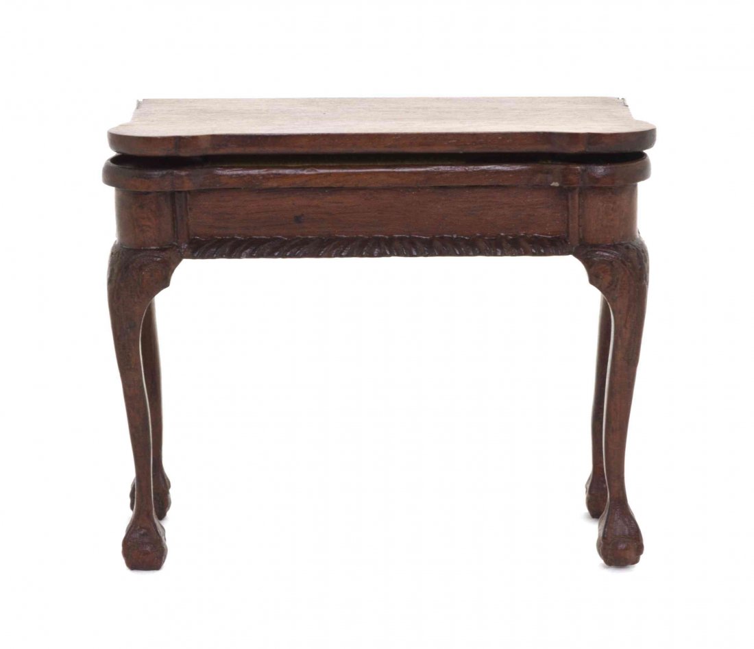 A Chippendale Style Walnut Games Table, Height 2 3/4 x: A Chippendale Style Walnut Games Table, having a rectangular top with turret corners over the conforming frieze with a gadrooned edge, raised on cabriole legs with acanthus carved knees ending in webb