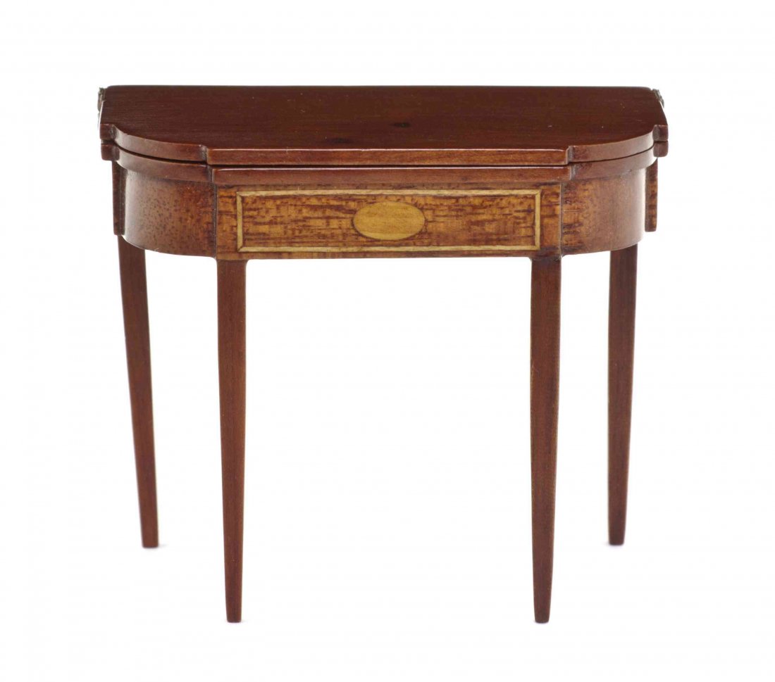 An American Hepplewhite Style Cherry Games Table,: An American Hepplewhite Style Cherry Games Table, Attributed to Eric H. Pearson, having a rectangular flip-top with ovolo corners over the conforming frieze having satinwood inlays, raised on square t