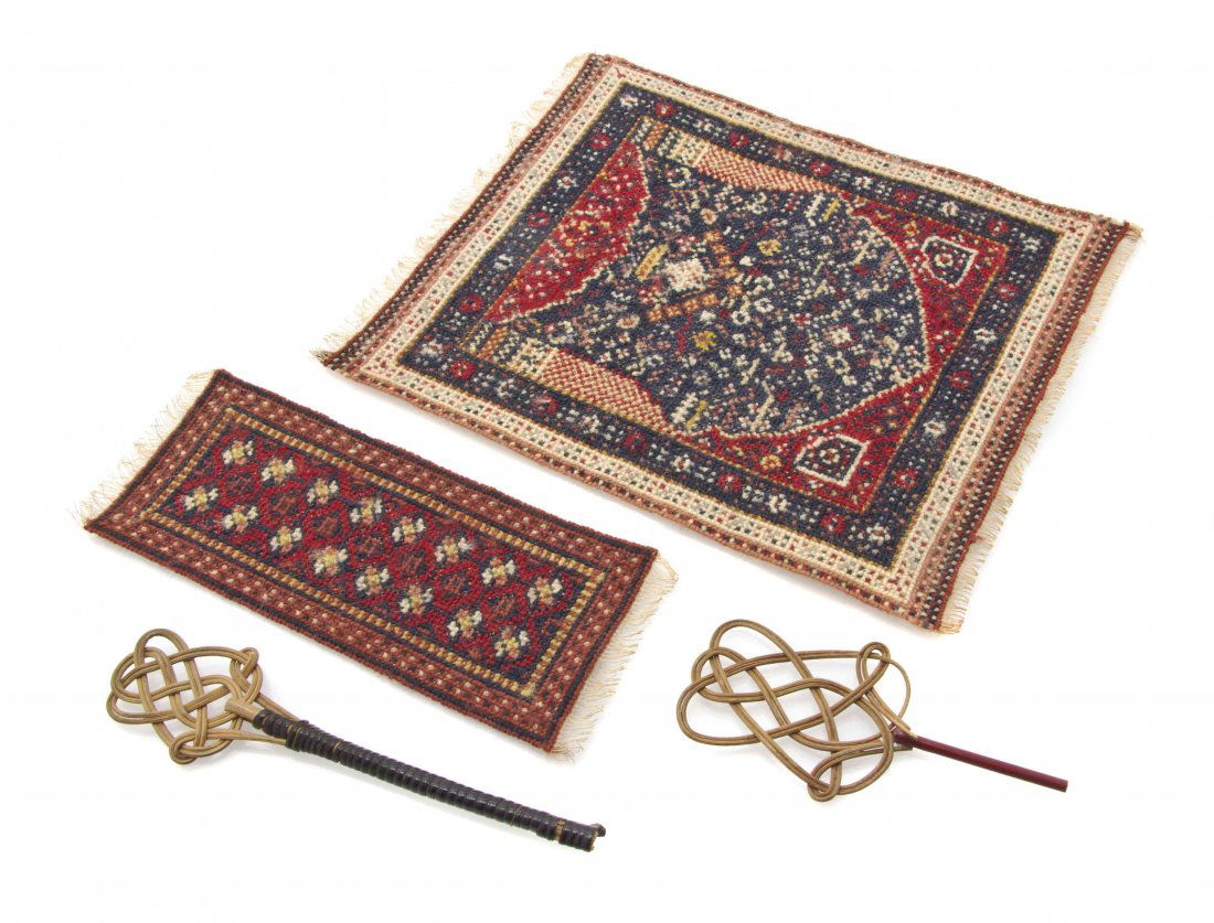 Two Needlepoint Rugs, Dimensions of largest 9 1/4 x 7: Two Needlepoint Rugs, comprising a directional example and a runner, together with two rug beaters. Dimensions of largest 9 1/4 x 7 1/2 inches. The Adell Venus Collection of Miniatures Property from t