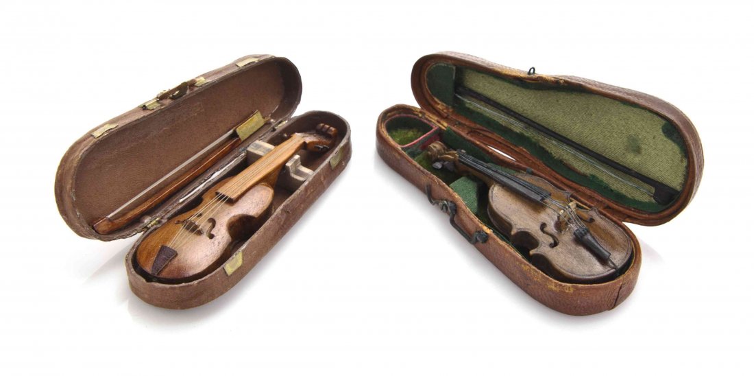 Two Diminutive Leather Cased Violins, Length of longer: Two Diminutive Leather Cased Violins, complete with bows, one case inscribed This. - J. E. Woodman. Length of longer case 3 inches. The Adell Venus Collection of Miniatures Property from the Estate of
