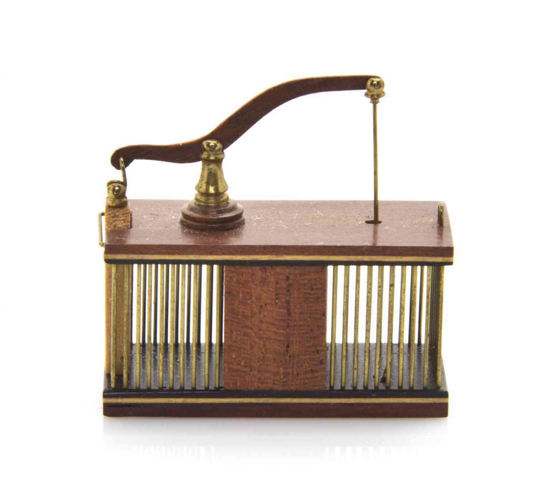 A Walnut, Maple, Ebonized Wood and Brass Rodent Trap,: A Walnut, Maple, Ebonized Wood and Brass Rodent Trap, William R. Robertson, of rectangular form with a fall front door, the underside bearing a tag engraved WM R Robertson 85. Width 15/16 inch. The Ad