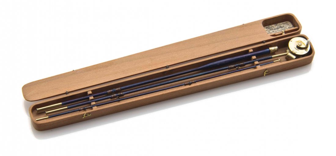 A Cherry Cased Fly Rod Set, William R. Robertson,: A Cherry Cased Fly Rod Set, William R. Robertson, comprising a reel, engraved with a father and son fishing, three-piece rod and a handle, set in the fitted case with two swing latch closures, having 
