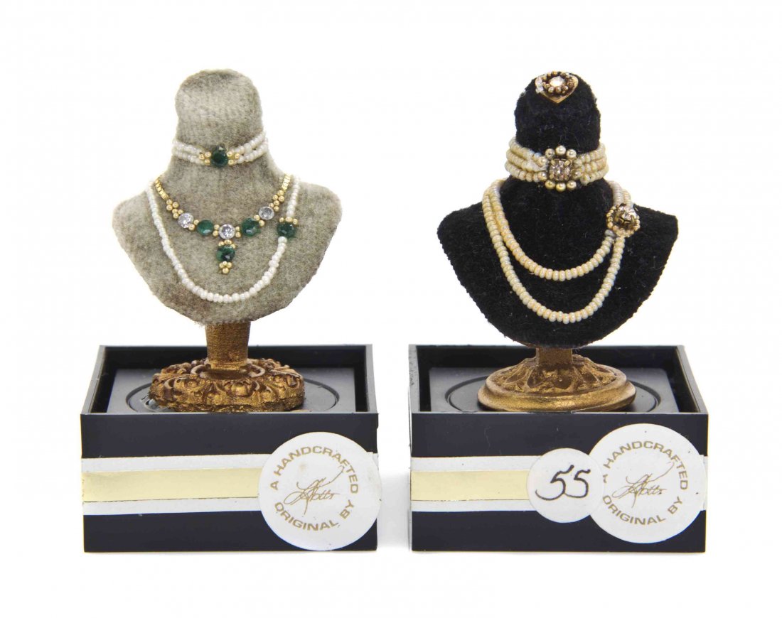 Two Suites of Jewelry on Display Busts, Lori Ann Potts,: Two Suites of Jewelry on Display Busts, Lori Ann Potts, each comprising a choker and two necklaces, both with seed pearls and 14K gold, one set with diamonds and emeralds, the other lacking identifyin