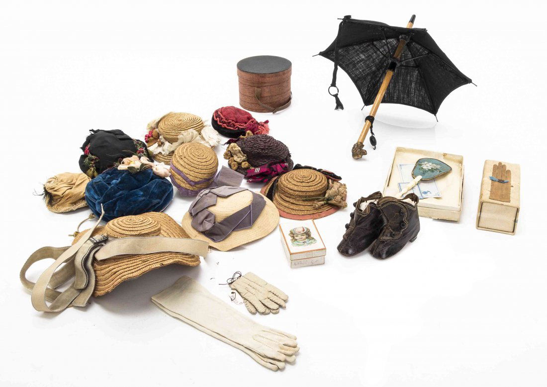 A Trunk of Doll Clothes and Accessories, Width of trunk: A Trunk of Doll Clothes and Accessories, comprising mostly vintage French fashion examples with some retaining the original boxes and cards, comprising ten hats, a hat box, umbrella, boots, three pair