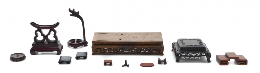 A Group of Twenty-Two Carved Wood Stands, Width of: A Group of Twenty-Two Carved Wood Stands, of various forms and sizes, together with a hardstone example. Width of widest 4 5/8 inches. The Adell Venus Collection of Miniatures Property from the Estate