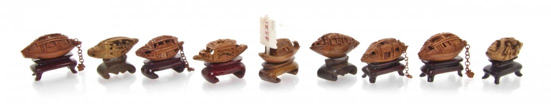 Nine Chinese Carved Peach Pits of Junk Boats, Width of: Nine Chinese Carved Peach Pits of Junk Boats, with articulating shutters, each raised on a hardwood stand. Width of widest 1 1/2 inches. The Adell Venus Collection of Miniatures Property from the Esta