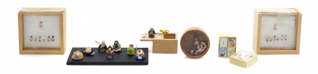 A Collection of Japanese Decorative Articles, Width of: A Collection of Japanese Decorative Articles, comprising a Samurai surprise box, four decks of print cards, a set of seven painted clay immortals, two sets of seven painted rice grain immortals, and a