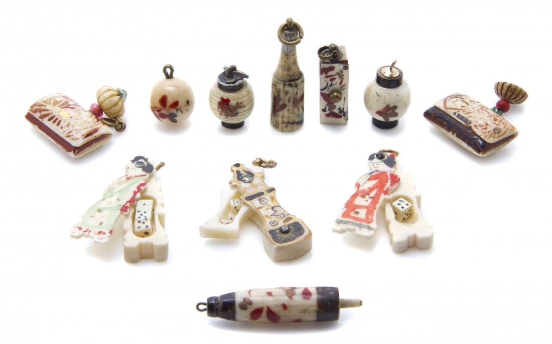 Eleven Japanese Bone Dice Boxes, Height of tallest 1: Eleven Japanese Bone Dice Boxes, comprising four lanterns, two figures, two tobacco pouches, a bottle, an umbrella, and a box-form example. Height of tallest 1 1/8 inches. The Adell Venus Collection o