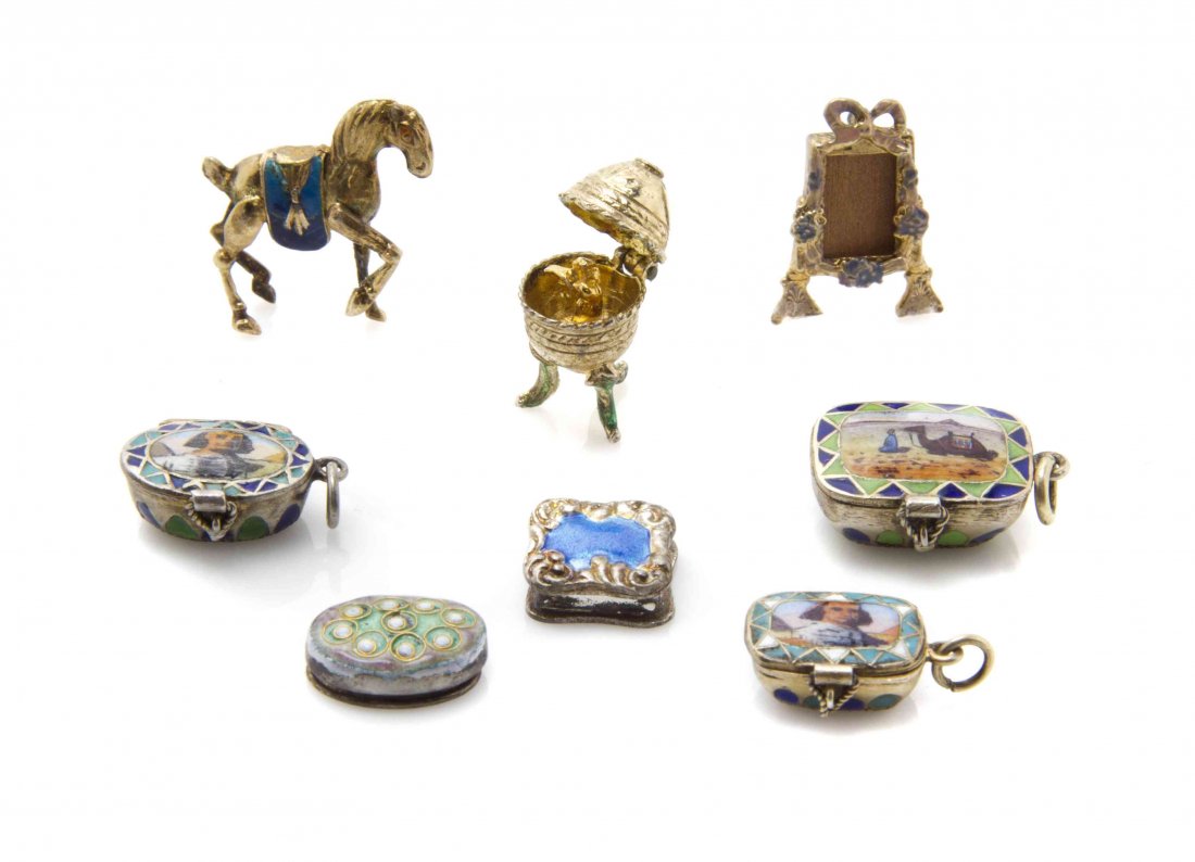 A Collection of Enameled Diminutive Articles, Width of: A Collection of Enameled Diminutive Articles, comprising three continental silver Moses basket charms, each stamped 800 and complete with baby Moses inside, a Faberge style egg, a Eugene Kupjack frame