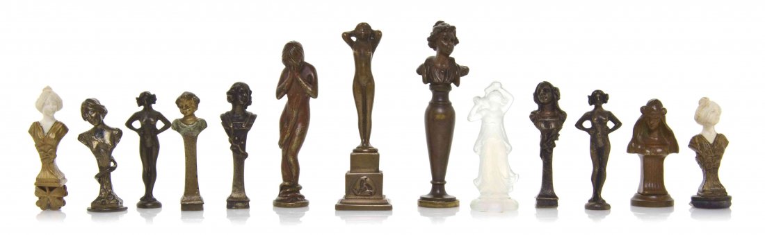 A Collection of Twelve Art Nouveau Figural Seals,: A Collection of Twelve Art Nouveau Figural Seals, comprising full nude figures and busts, including two with ivory heads, together with a Sabino opalescent glass figure of a maiden. Height of tallest 