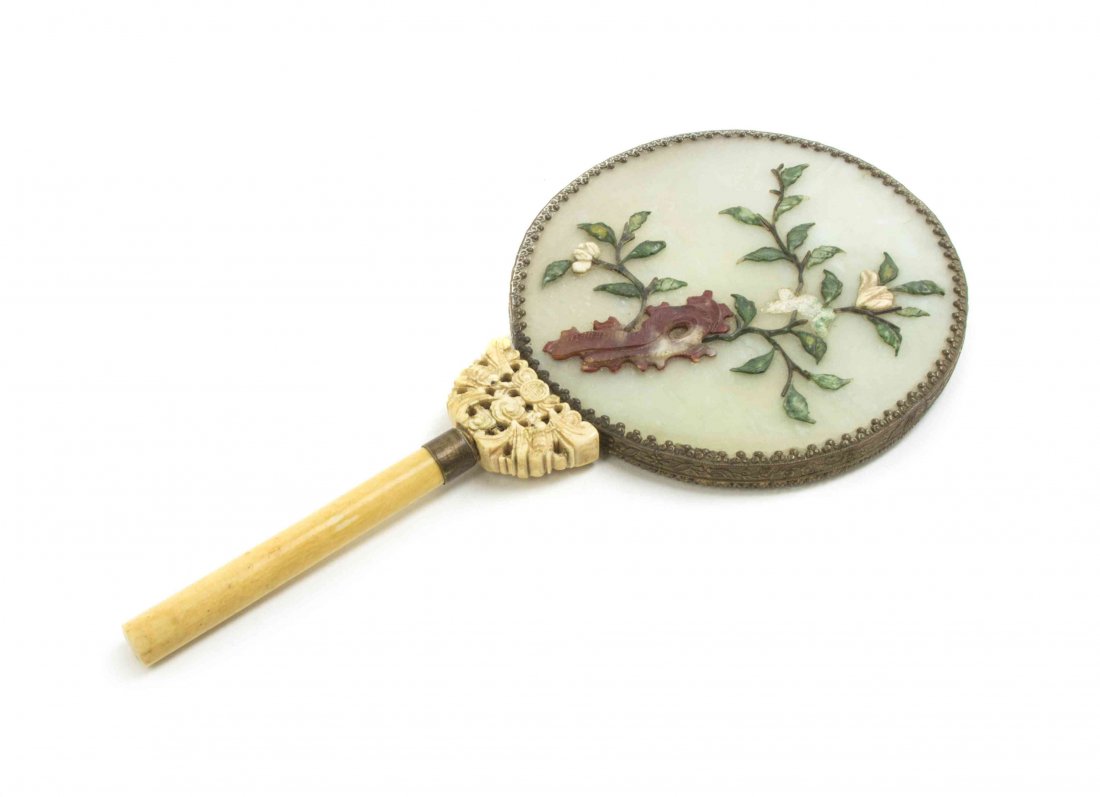 A Chinese Hand Mirror, Length overall 10 1/8 inches.: A Chinese Hand Mirror, having hardstone back with floral decoration, with an ivory cylindrical handle joined by a pierced ivory plaque having bat and shou medallion motif. Length overall 10 1/8 inches