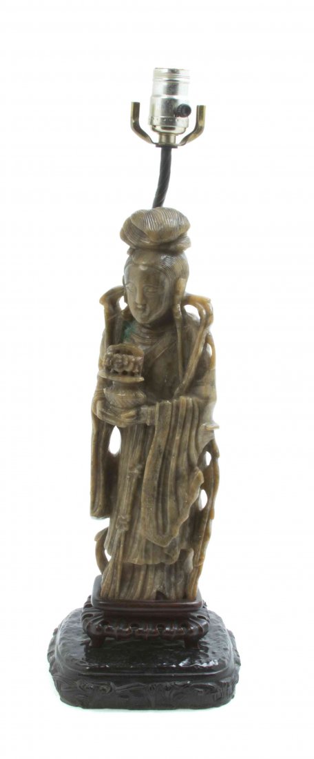 A Chinese Carved Soapstone Figure, Height 13 1/2: A Chinese Carved Soapstone Figure, depicting a standing Guanyin holding a potted flower, mounted as a lamp. Height 13 1/2 inches.