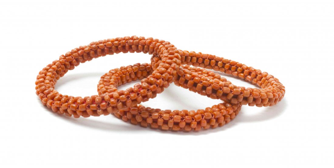Three Coral Beaded Bangles, Diameter 3 3/4 inches.: Three Coral Beaded Bangles, each of circular form comprised of a composition of small coral beads woven together with coral colored thread. Diameter 3 3/4 inches.