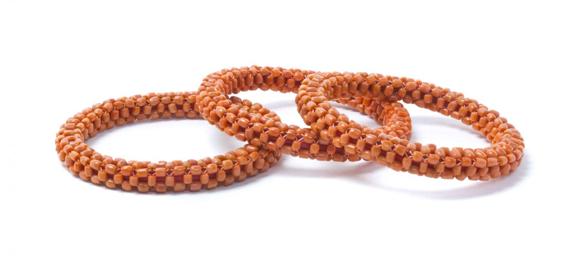 Three Coral Beaded Bangles, Diameter 3 3/4 inches.: Three Coral Beaded Bangles, each of circular form comprised of a composition of small coral beads woven together with coral colored thread. Diameter 3 3/4 inches.